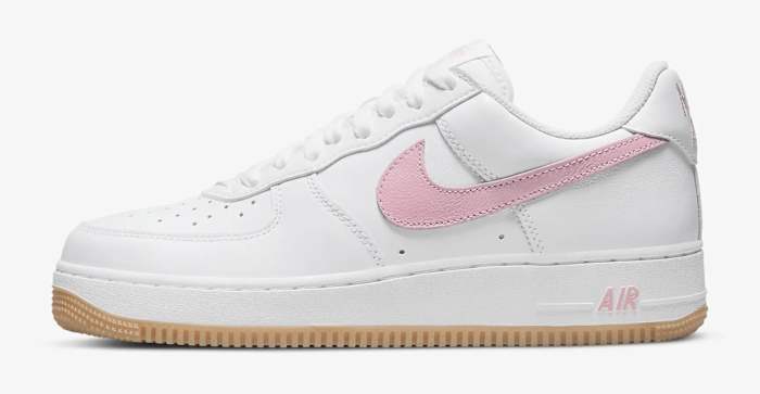 Side view of a white and pink Nike Air Force 1 shoe.